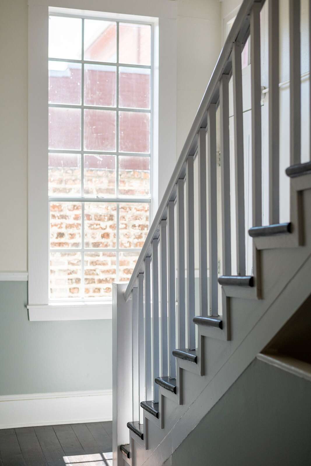 A staircase with a railing and a window