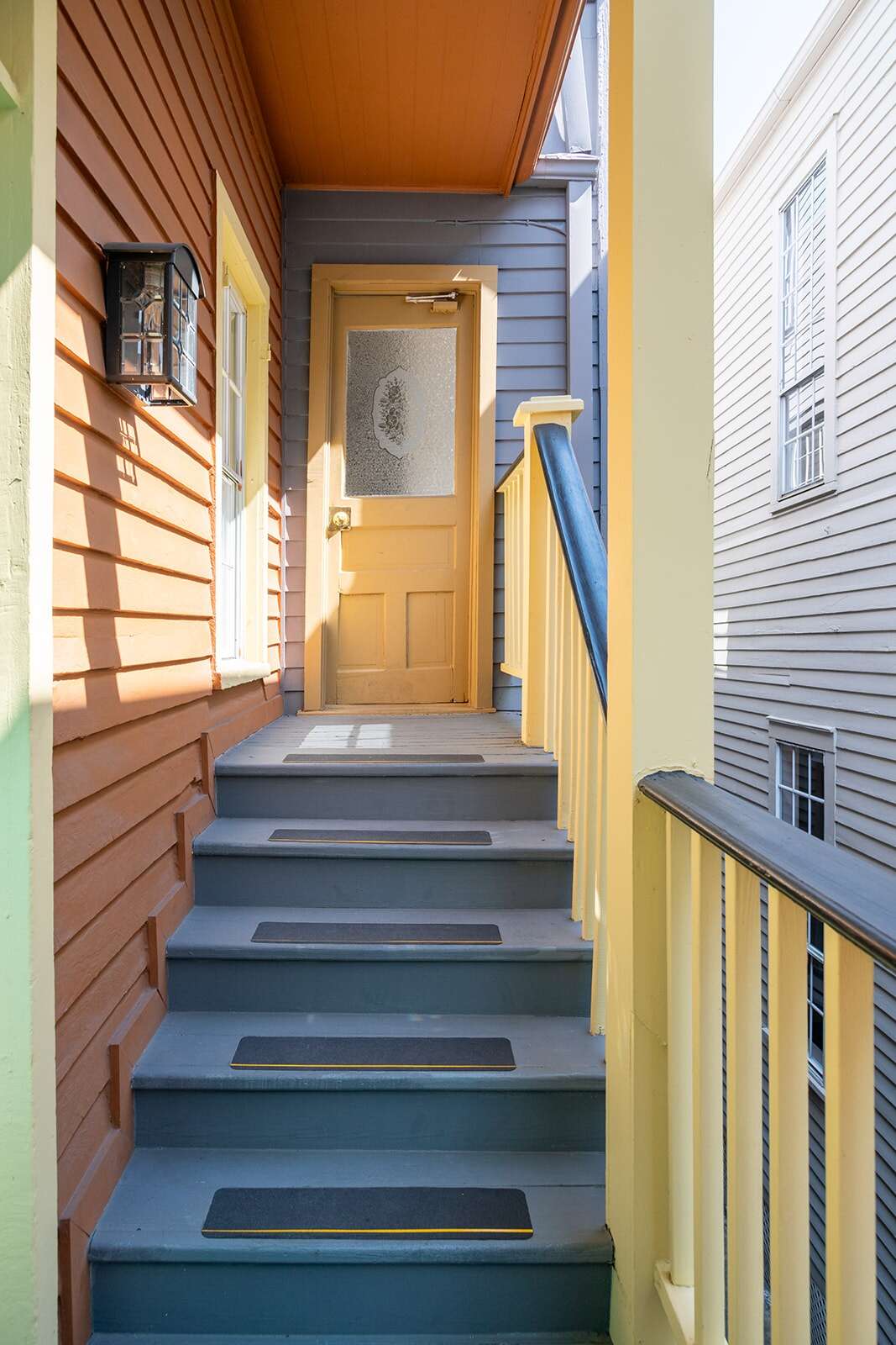 A colorful exterior stairway leading to a door